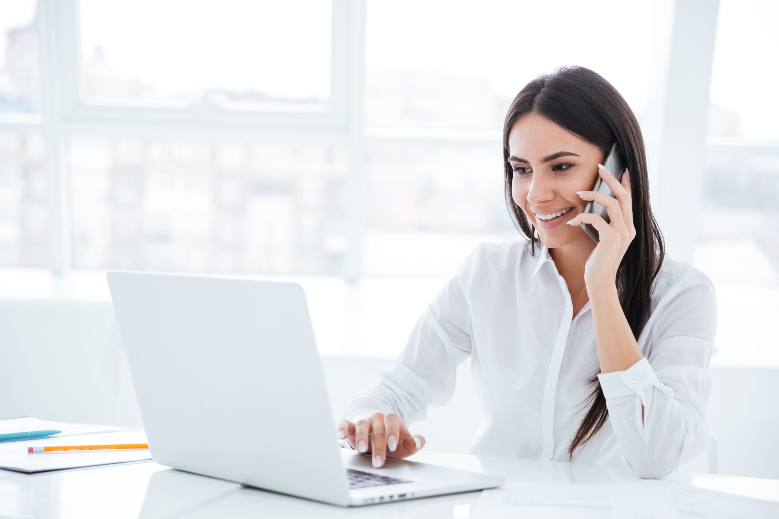 Side view Business woman talking at phone by the table